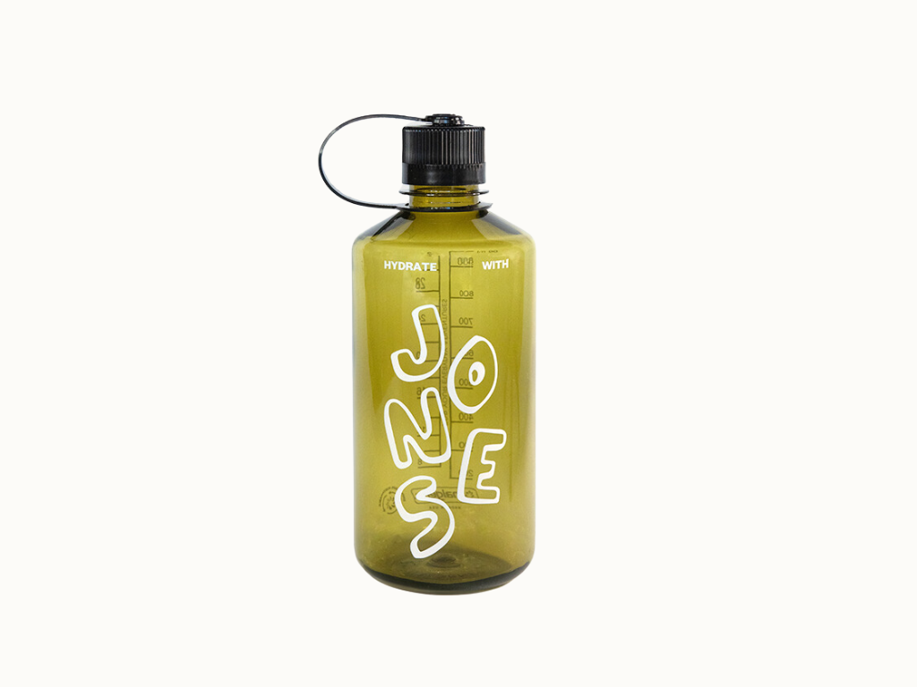 The Jones 32oz Nalgene by Quit with Jones is a translucent olive green recycled plastic water bottle with a black loop-handle screw cap and white graffiti text reading "JUNE JOSE.