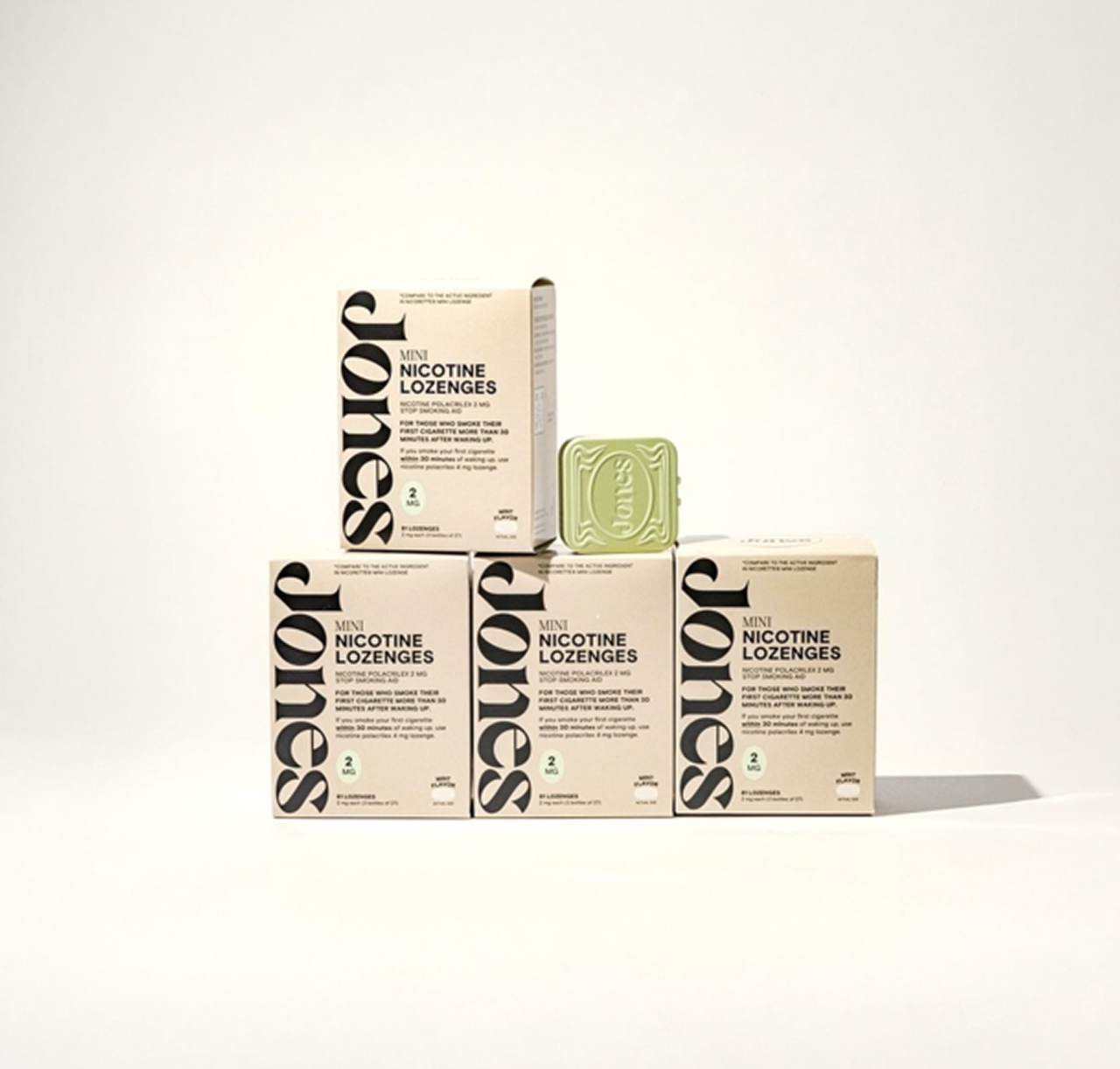 Two tan-colored Jones Sampler boxes are shown—one upright with a green lozenge container on top, the other leaning beside it. Text highlights the Jones brand name, 2mg nicotine mints, and mint flavor.