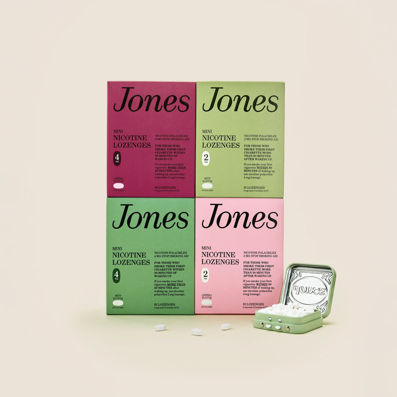Five green boxes labeled "Jones Habit Kicker" are stacked geometrically on a beige background. Three white lozenges, part of this nicotine quit kit, are displayed in front. The boxes have minimalist text and icons.