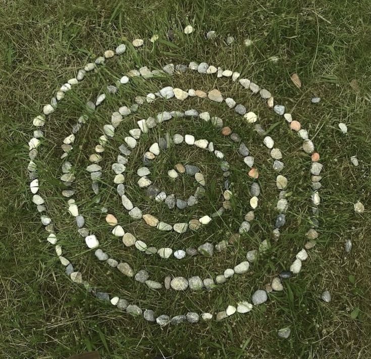 stones forming a spiral shape on grass