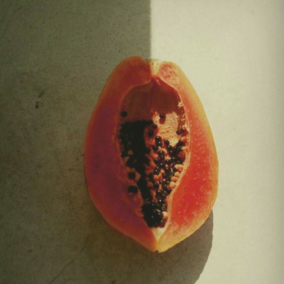 papaya on a green surface