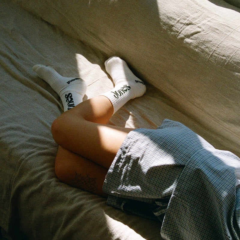girl in jones socks laying on couch