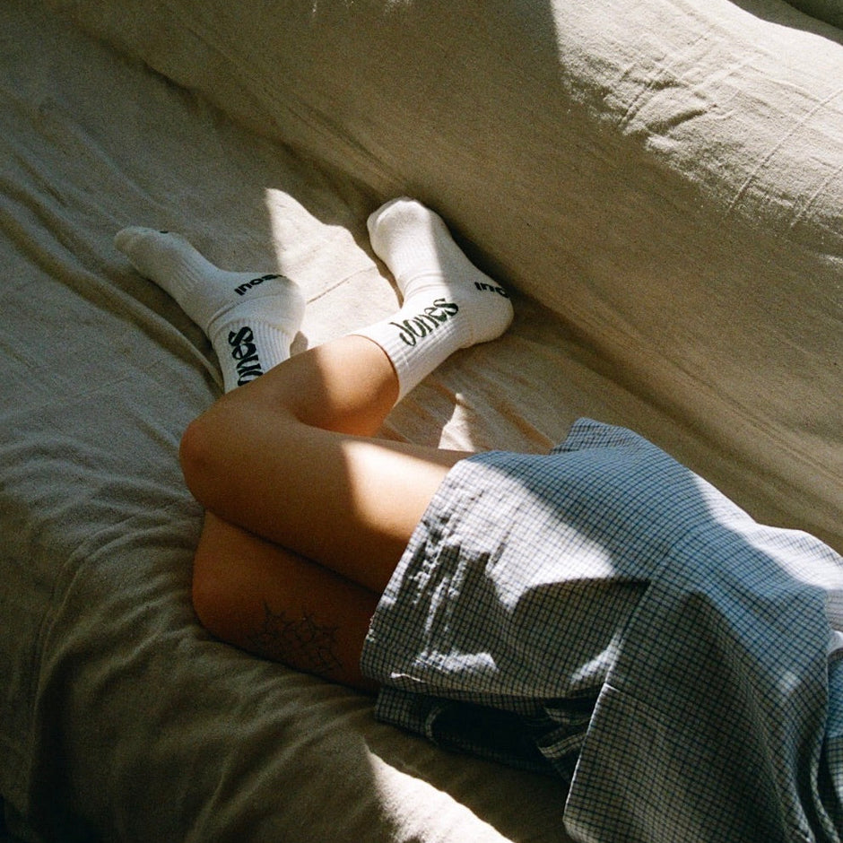girl in jones socks laying on couch
