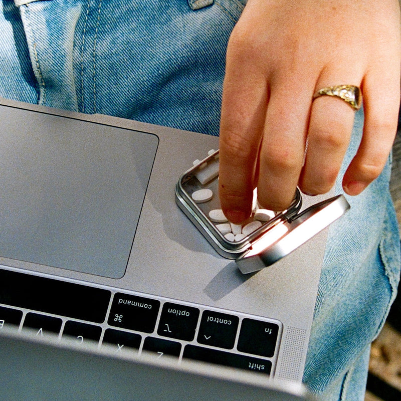 hand taking jones mint out of tin