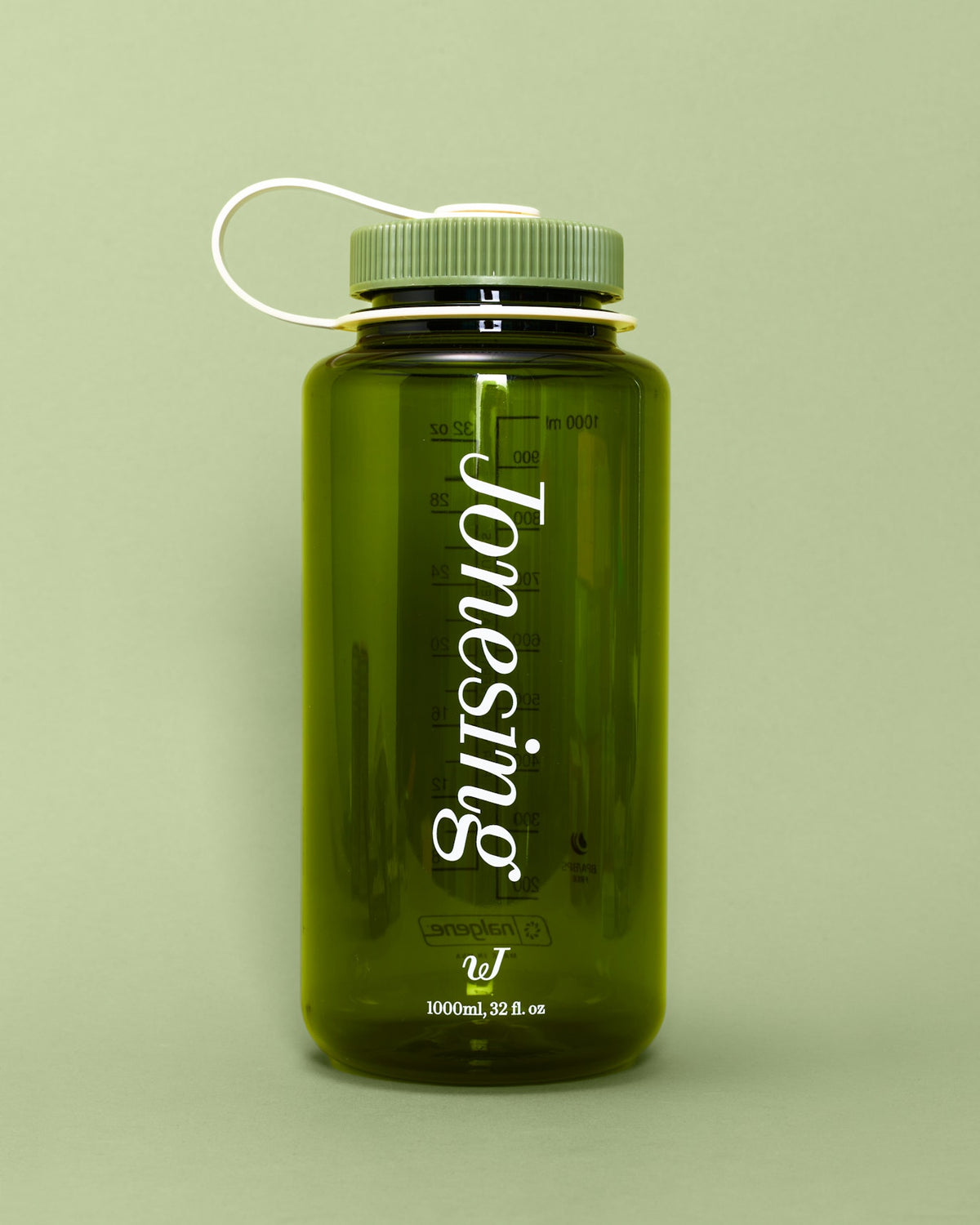 A transparent olive-green Jonesing Water Bottle stands against a matching light-green background, featuring a ribbed green cap with a white loop, the word “Jonesing” printed vertically, and measurement markings along the side.