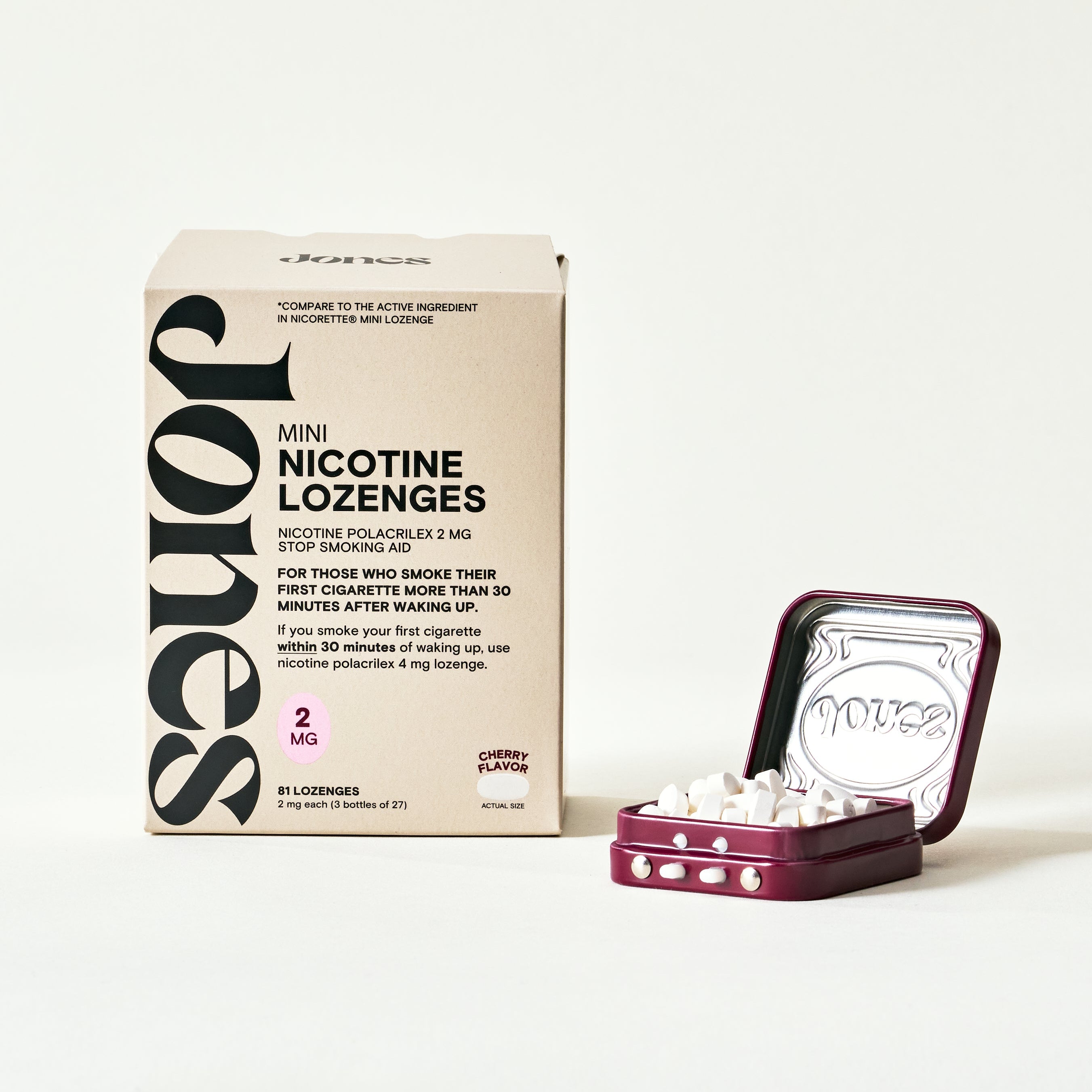 A hand holding a small square metal tin with embellishments labeled Jones that contains FDA-approved Jones nicotine replacement therapy lozenges and a cell phone screen showing an app to quit vaping by Jones with money saved, streak, and daily nicotine tracking.