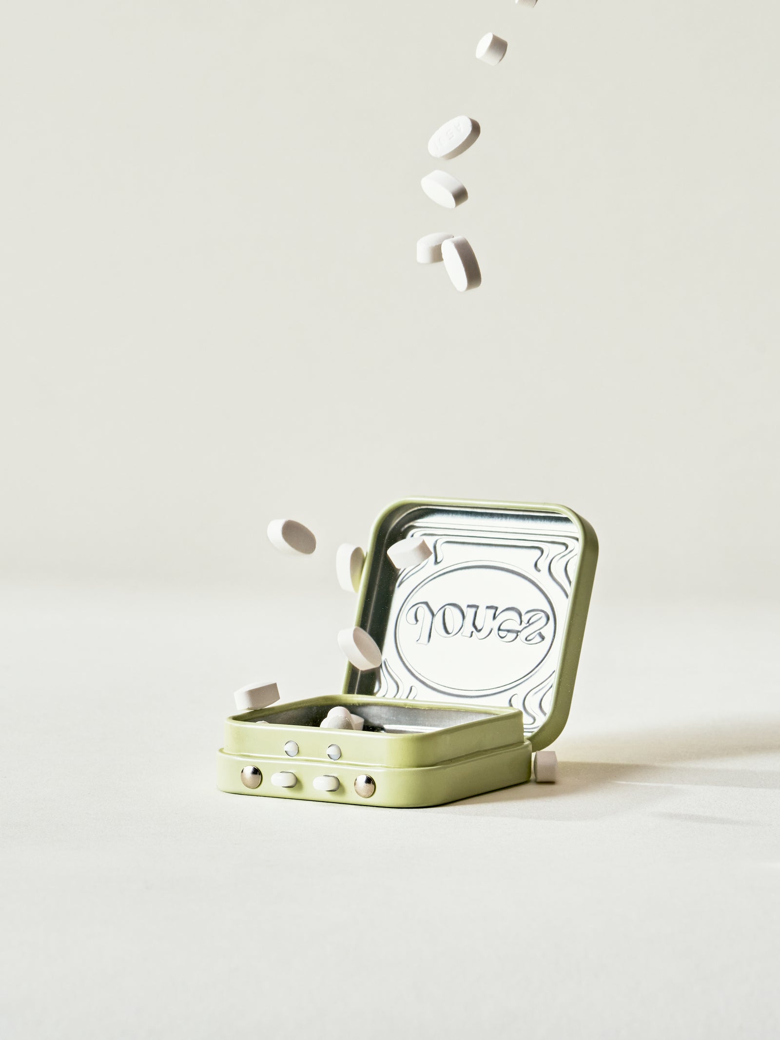 Four boxes of Jones (OLD) Switcher Upper lozenges are stacked, with one tin on top. Each box features bold black branding and product details, making them perfect for cravings support.