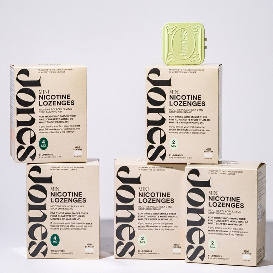 Four boxes of Jones Heavy Hitter are stacked in a pyramid with a green lozenge case on top—perfect to support your quit plan or as a nicotine mint alternative on your journey to quit smoking.