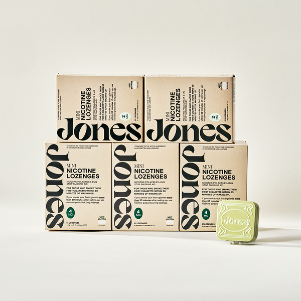 Two tan-colored Jones Sampler boxes are shown—one upright with a green lozenge container on top, the other leaning beside it. Text highlights the Jones brand name, 2mg nicotine mints, and mint flavor.